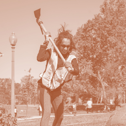 a volunteer swinging a pickaxe