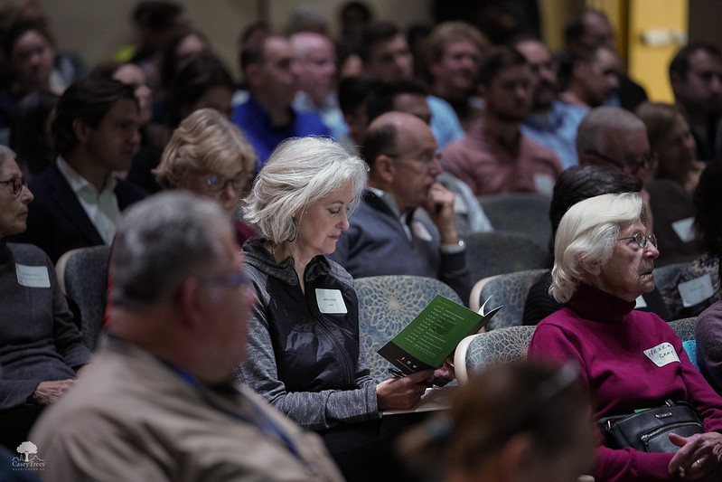 An audience member reading the pamphlet