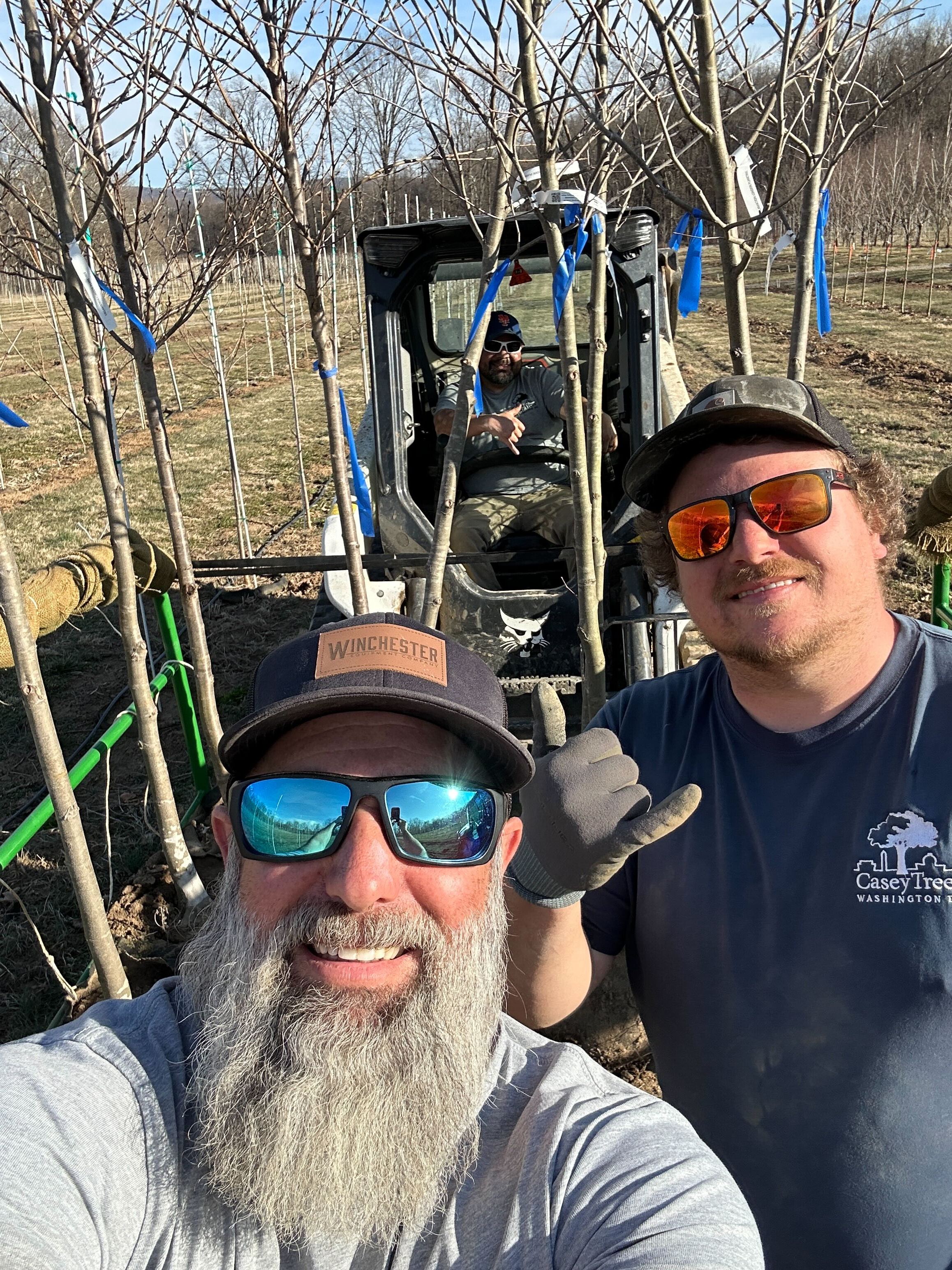 Farm crew selfie while digging trees