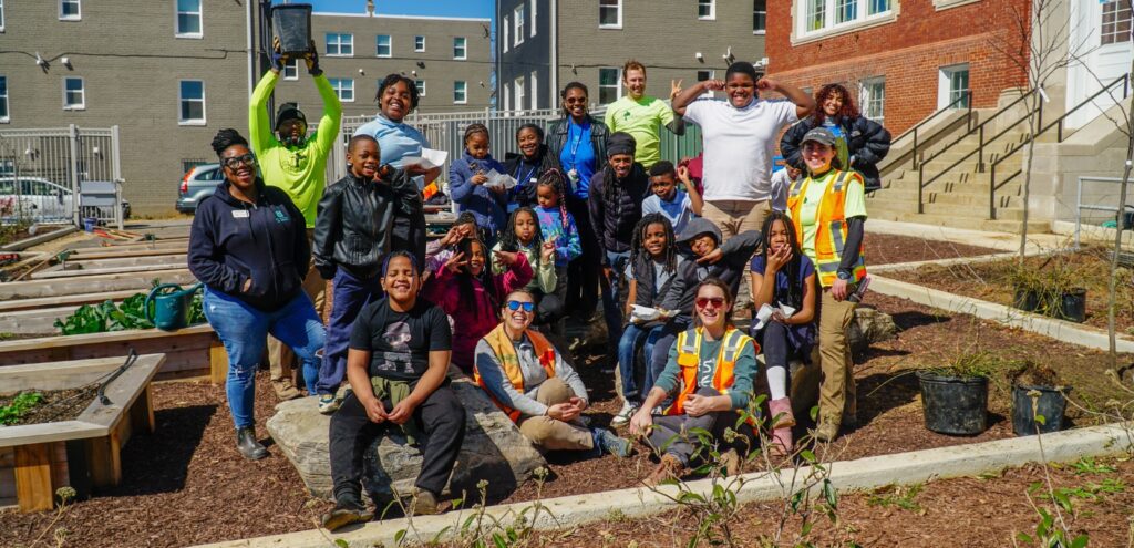 A FoodPrints class of fourth graders poses for a photo after a day of planting at Garfield Elementary