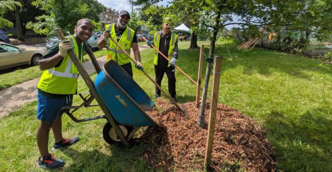 a team of volunteers drops mulch at a volunteer event in Emery Heights Park