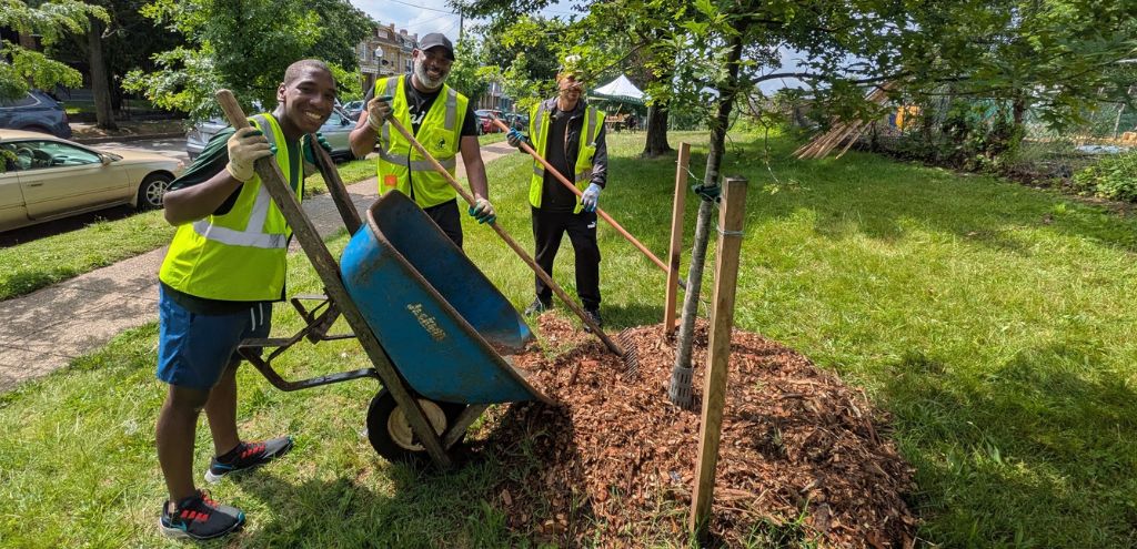 a team of volunteers drops mulch at a volunteer event in Emery Heights Park