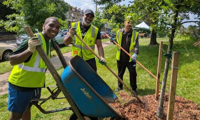 a team of volunteers drops mulch at a volunteer event in Emery Heights Park