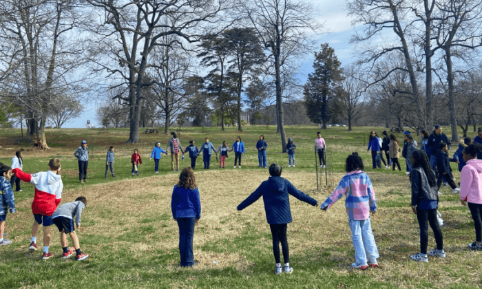Students stand in a circle at the National Arboretum