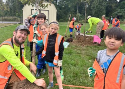 Students from Springfield Elementary school pose while planting trees on campus