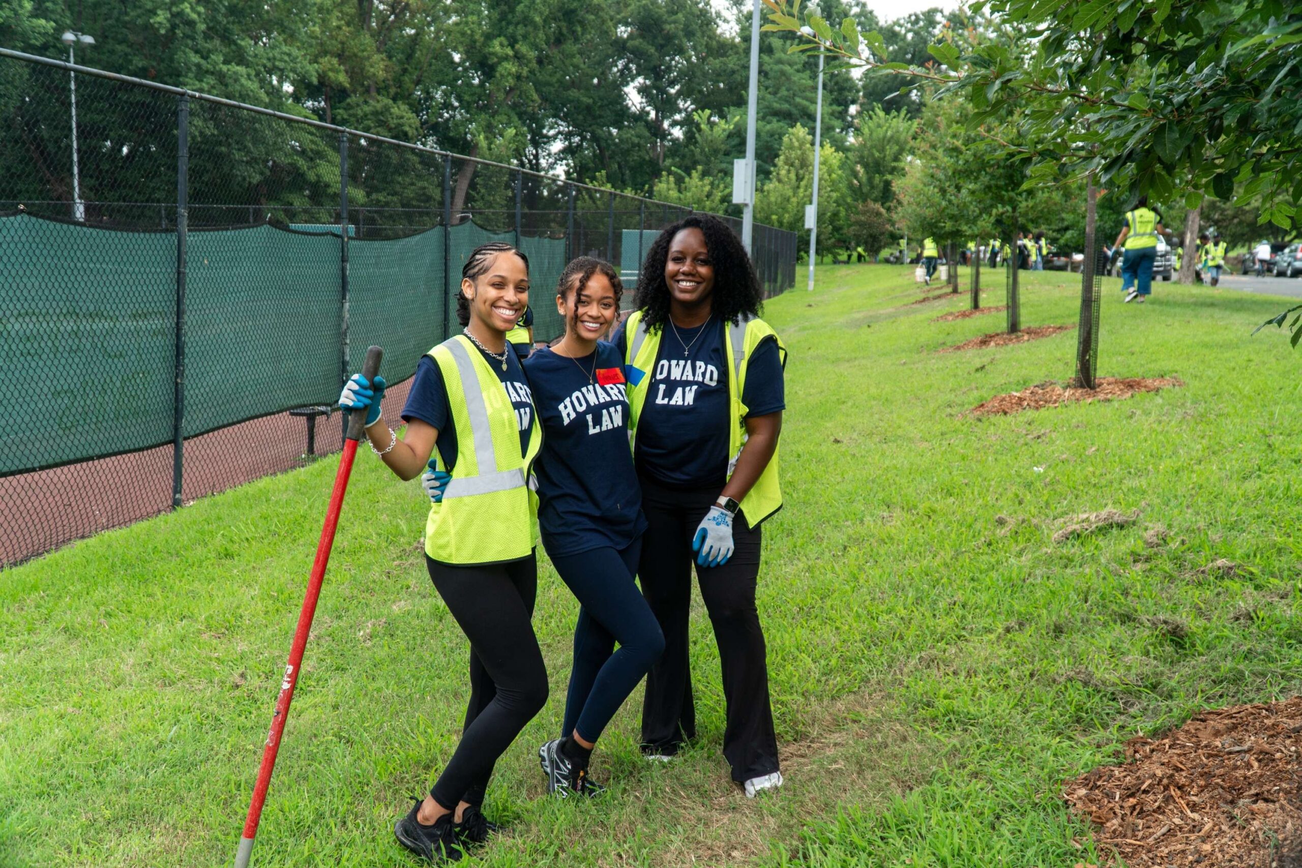 Three incoming Howard University Law students smile and pose for the camera.