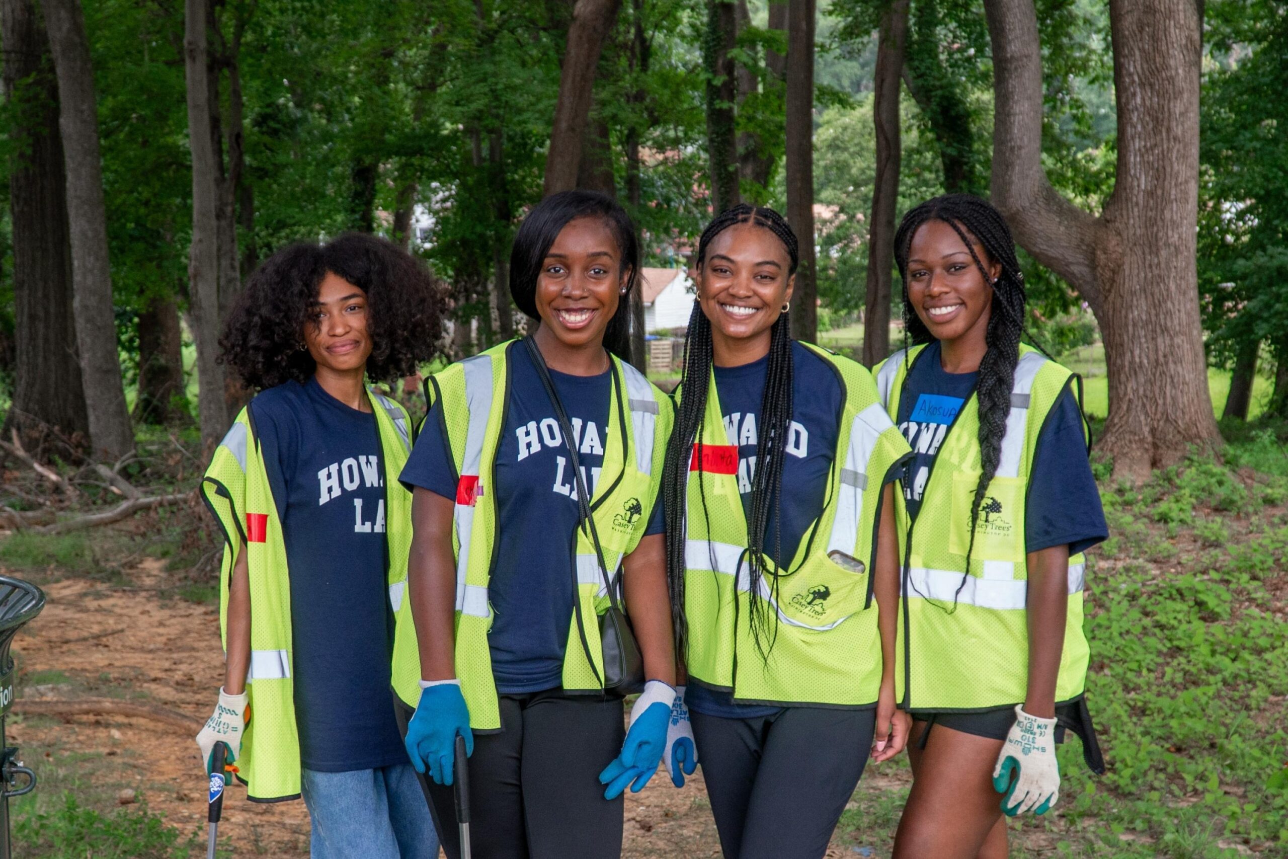 Four incoming Howard University Law students smile for the camera after picking up trash.