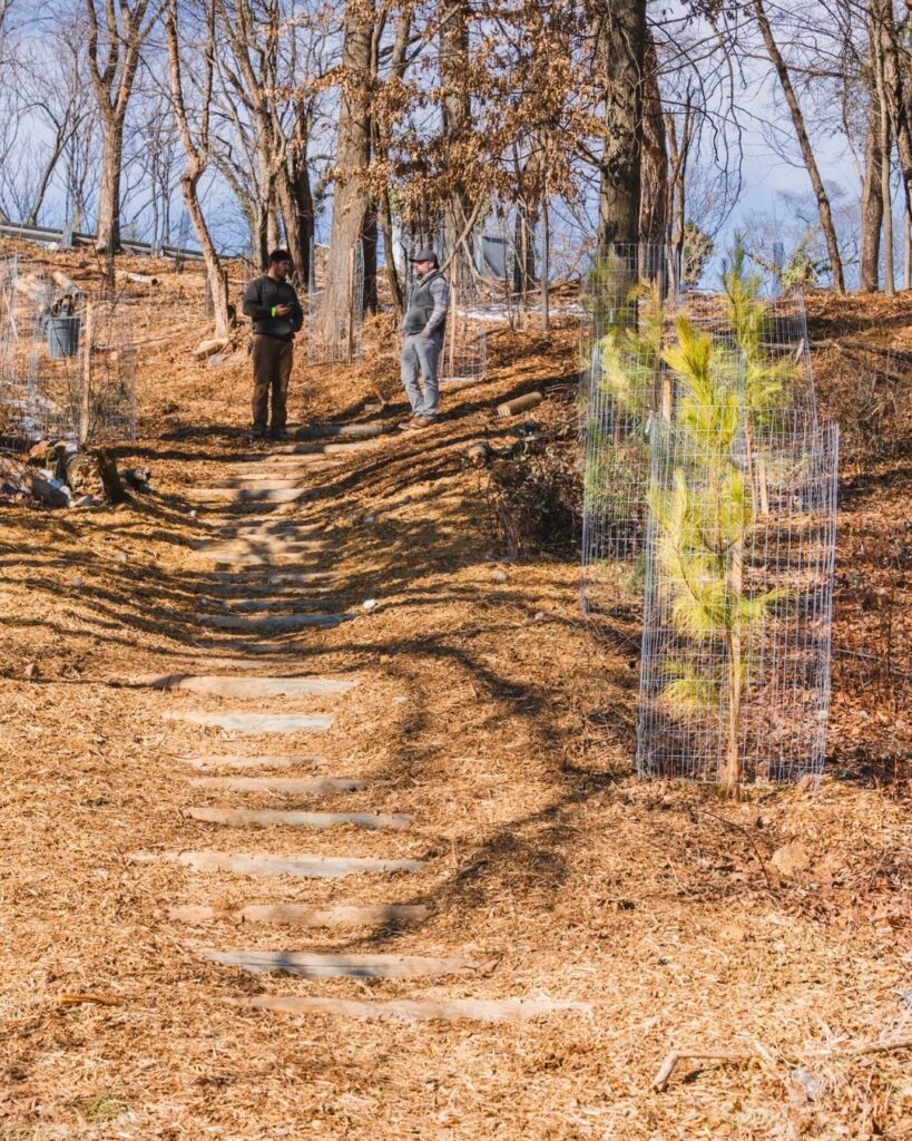 Two people stand on the trail at Hellbender Hill