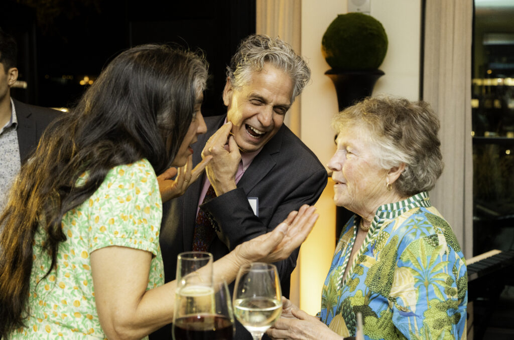 Mark Buscaino talking to guests and laughing