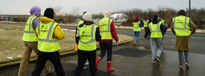 A group of volunteers in Casey Trees vests walk along a path.