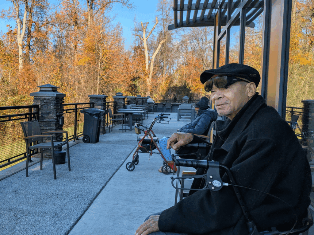 A man sitting on a porch looking at nature