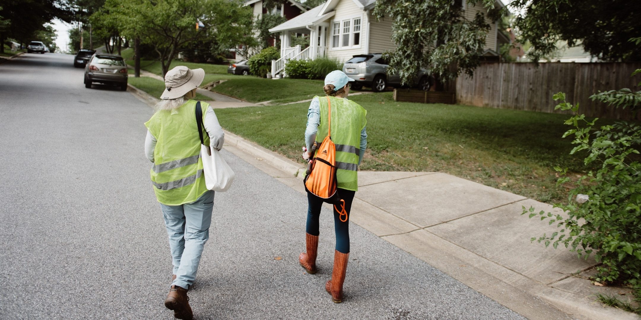 Two volunteers for CCAN walk on a road as they canvass.