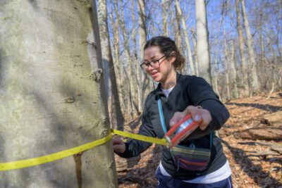 GCA Fellow Kendall McCoach measures a tree's diameter.