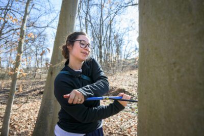 GCA Fellow Kendall McCoach takes core samples from trees in Newark’s William M. Redd, Jr. Park.