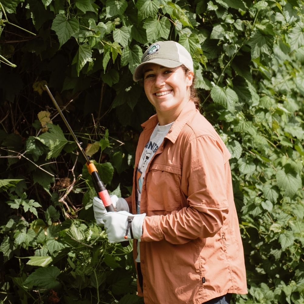 Photo of Meredith Prescott holding hedge trimmers.