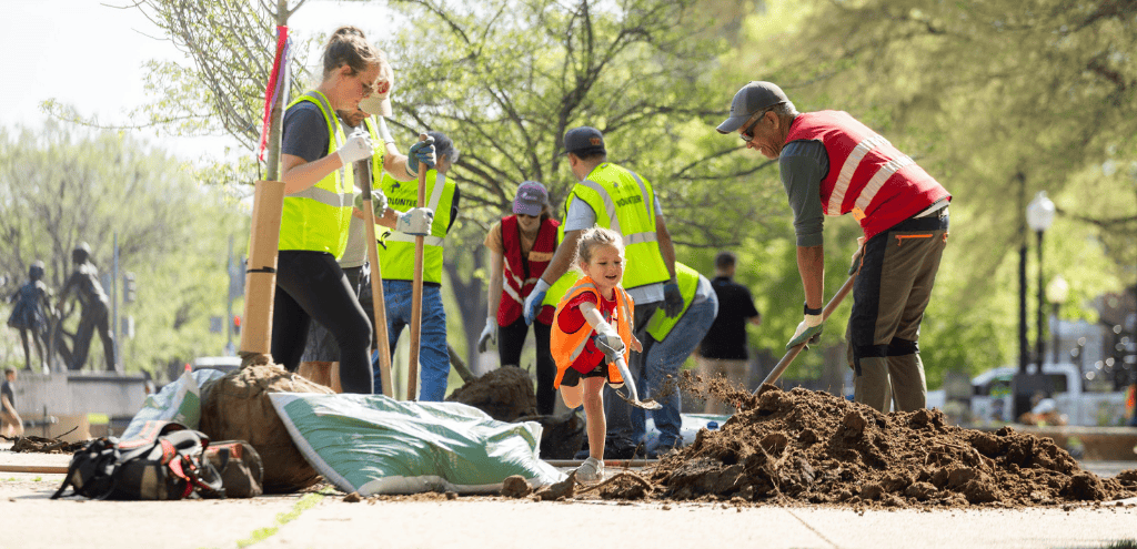 Volunteers planting a tree in Lincoln Park.