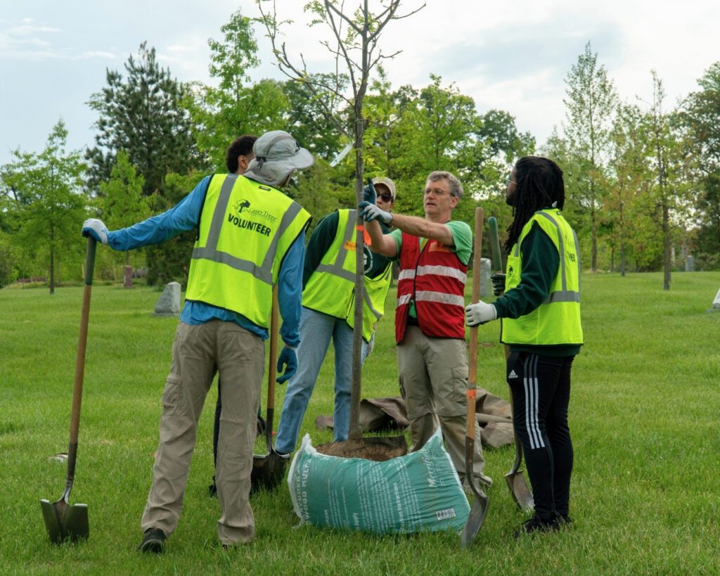 A Team Leader describes what tree they're planting to his group of volunteers.