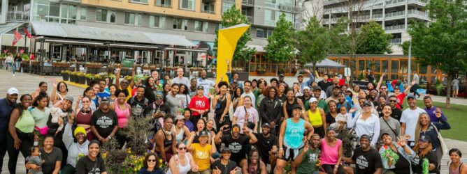 A large group of runners smile at a Soul Trak Outdoors event.