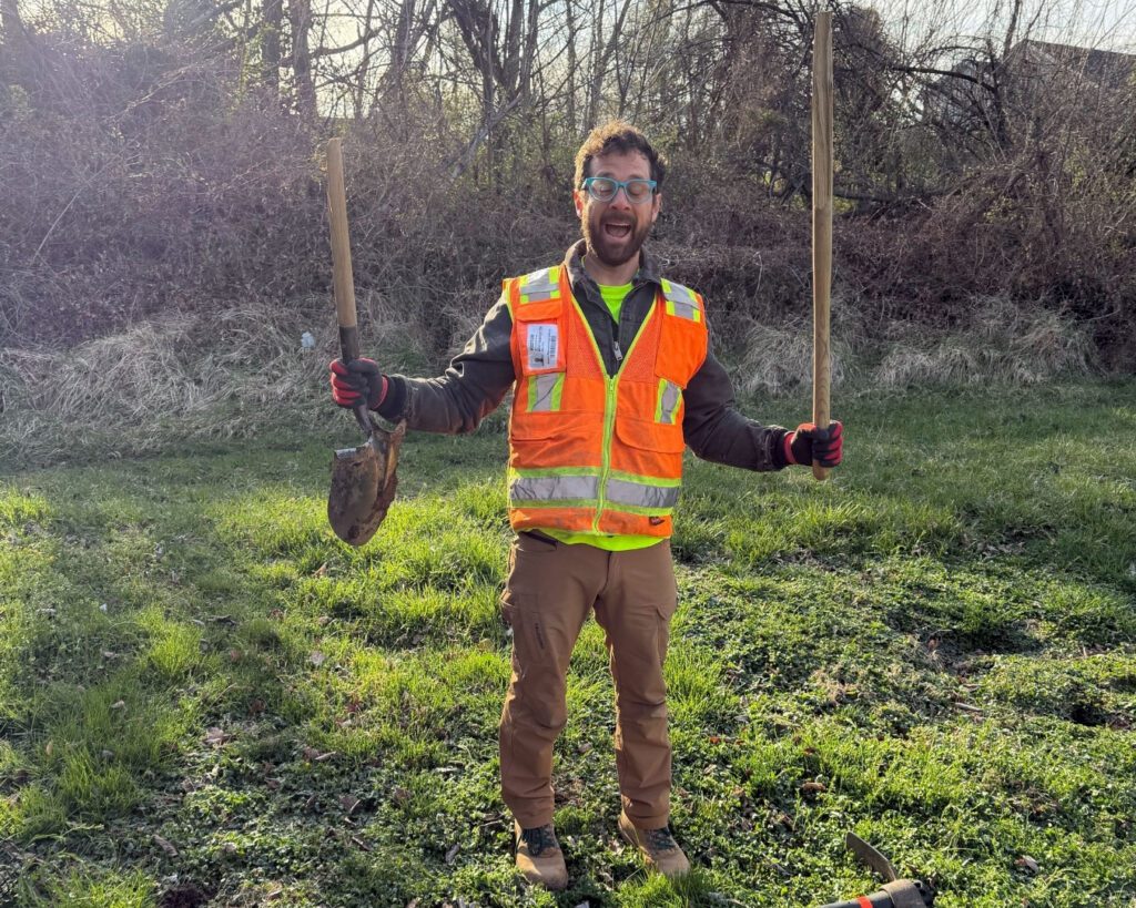 A Casey Trees employee holds up a broken shovel.