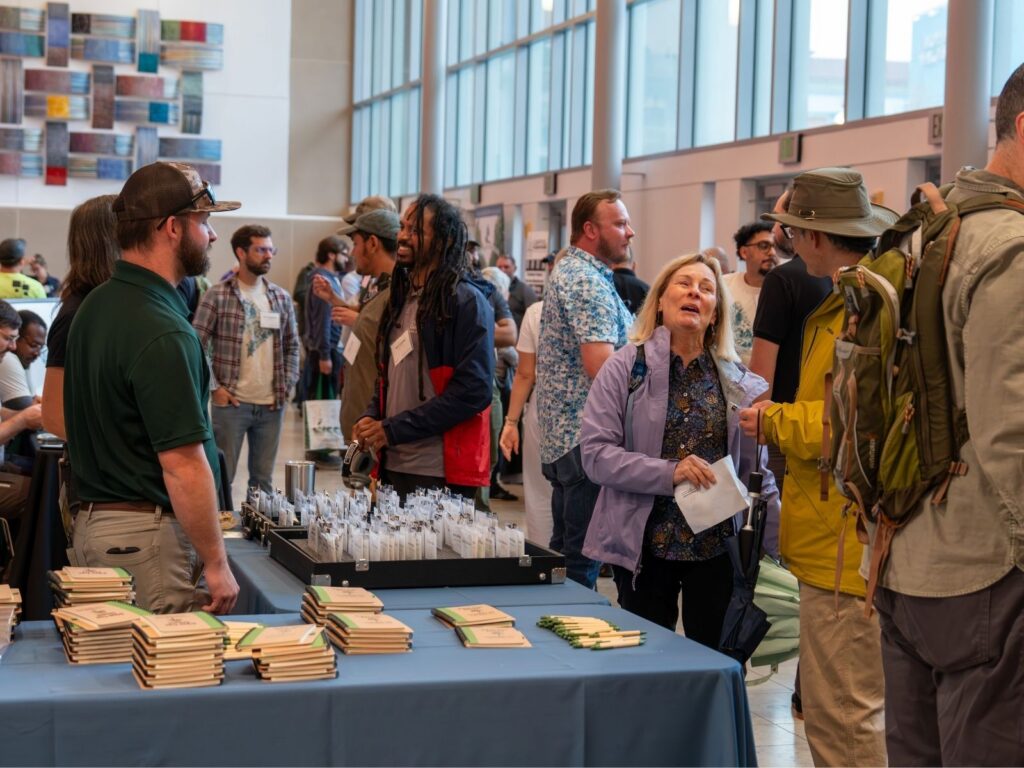 Attendees mingle as they check in to the Urban Tree Summit.